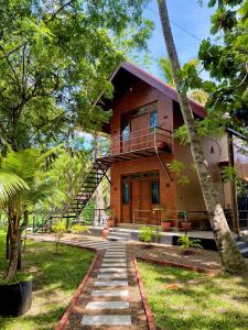 a house with a staircase leading up to it at The Green View Yala in Tissamaharama