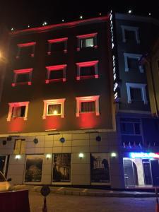 a building with red lights on the side of it at Ganita Life Hotel in Trabzon +8 photos
