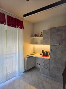 a kitchen with a white counter and a window at Ca' di Sara in Domodossola
