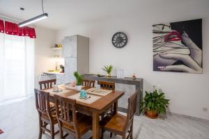 a kitchen and dining room with a wooden table and chairs at Ca' di Sara in Domodossola