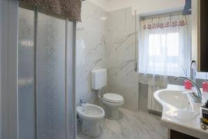 a bathroom with a toilet and a sink and a shower at Ca' di Sara in Domodossola +8 photos