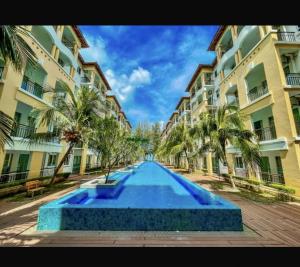 a large swimming pool in front of a building at Tiara Homestay Desaru - Garden Pool View in Bandar Penawar