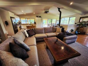 a living room with a couch and a coffee table at The Shed House in Mount Beauty