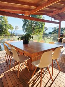 a wooden table and chairs on a deck at The Shed House in Mount Beauty