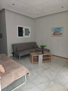 a living room with a couch and a coffee table at Irene's home in Igoumenitsa