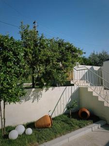a building with a staircase and some plants and trees at Alba Terra Houses in Pamukkale