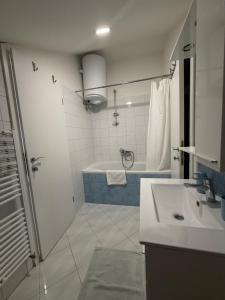a bathroom with a sink and a shower and a tub at Villa Fragola in Doli +18 photos