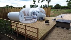 a circular house with a living room in a backyard at La Bulle des Brosses étoilées in Igé