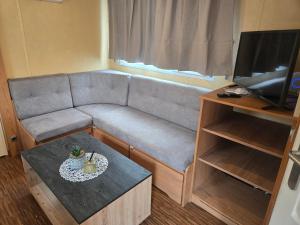 a living room with a couch and a table at Kopićland HOMES in Marinci