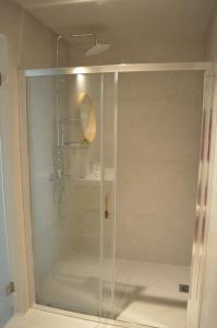 a shower with a glass door in a bathroom at Downtown apartment - Signature in Kamena Vourla +32 photos