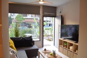 a living room with a couch and a large sliding glass door at Downtown apartment - Signature in Kamena Vourla