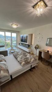 a bedroom with a large bed and a living room at Sweet Dream in Dolný Kubín