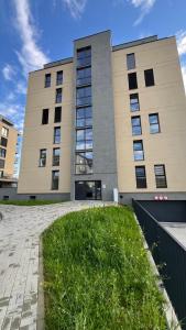 a large building with a lawn in front of it at Sweet Dream in Dolný Kubín