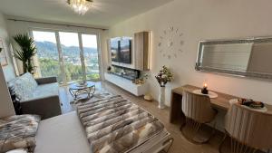 a living room with a couch and a table and a clock at Sweet Dream in Dolný Kubín