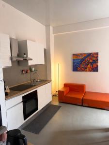 a kitchen with an orange couch and a sink at Nice Sea Suite in Salerno +21 photos