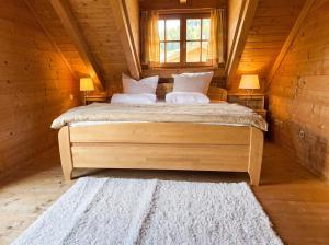 a bedroom with a bed in a wooden cabin at Ferienhaus John in Saarwellingen +2 photos