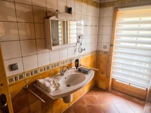 a bathroom with a sink and a mirror at Ferienhaus John in Saarwellingen