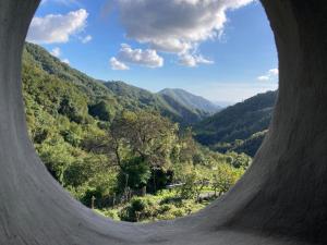 a view of a valley from a hole in a mountain at B&B PETITE PROVENCE Genova in Ceranesi