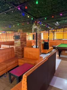 a gaming room with couches and a pool table at Residence Singa in Abidjan