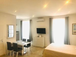 a bedroom with a desk and a bed and a television at Summer Home No. 8 in Fažana