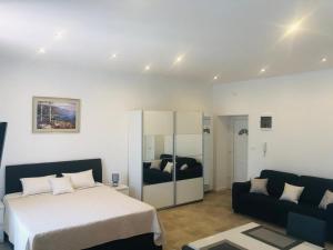 a bedroom with a bed and a couch at Summer Home No. 8 in Fažana