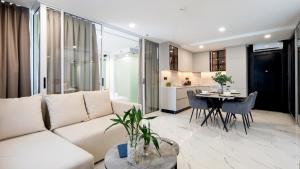 a living room with a white couch and a table at Andaman Riviera in Bang Tao Beach +33 photos