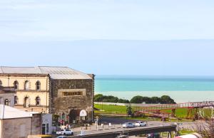 a view of a building and a bridge with cars on a road at Oamaru Backpackers in Oamaru