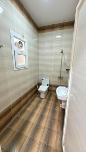 a bathroom with a toilet and a sink at شقة صحلنوت in Salalah
