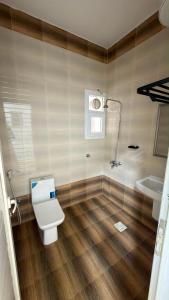 a bathroom with a toilet and a sink at شقة صحلنوت in Salalah