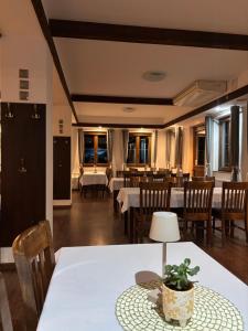 a dining room with a white table and chairs at Serenity Residence Hotel & Wellness in Liptovský Trnovec