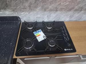 a stove top with four burners on top of it at espaço completo só para você e seus familiares in Gravatá