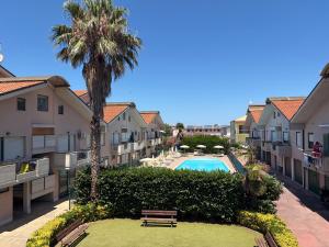an apartment complex with a pool and palm trees at Polena Residence Hotel in Marina di Montenero