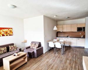 a living room with a couch and a table at Apartmán Všemina 346 in Všemina