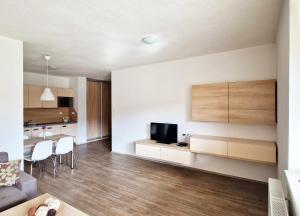 a living room with a couch and a tv on a wall at Apartmán Všemina 346 in Všemina +6 photos
