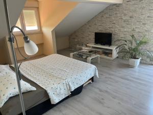 a bedroom with a bed and a flat screen tv at Apartment Sunset in Šibenik
