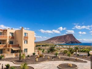 a view of a building with a mountain in the background at RenTenerife Elim Ocean in La Tejita