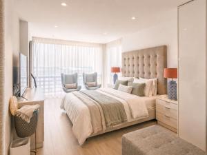 a bedroom with a large bed and a window at RenTenerife Elim Ocean in La Tejita +15 photos