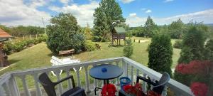 a balcony with a view of a yard with trees at Apartmani Ćosić in Kuršumlija