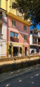 a building with a fence next to a street at Sa Domo Bonaria - Intero appartamento in Osilo