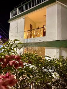 a building with a balcony with flowers in front of it at Casa Zo an entire fully furnished apartment in Āīzawl