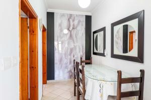a room with a table and some pictures on the wall at Villa Kevin's in Sarandë