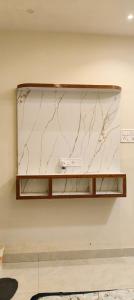 a shelf on a wall with a marble counter top at Hotel shivansh in Godarpura