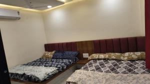 a room with two beds in a room at Hotel shivansh in Godarpura
