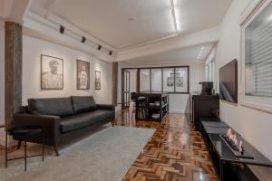 a living room with a couch and a television at Estúdio 196 in Bento Gonçalves