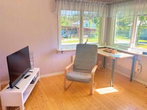 a room with a desk and a chair and a television at Hus Indalsälven in Hammarstrand