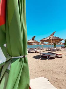 a view of a beach with umbrellas and chaises at Casa Ruxandrei in Constanţa