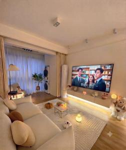 a living room with a white couch and a flat screen tv at Luxury apartment With 3 Ac and Free Parking in Lahore