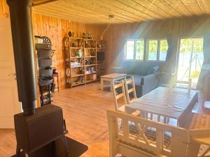 a living room with a wood stove and a table at Sodra Fullsjön in Stugun