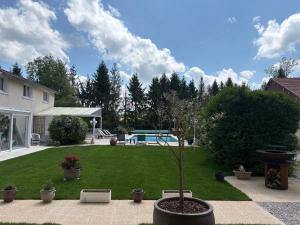 a small tree in a pot in a yard at Les Lodges de la Moivre in Saint-Jean-sur-Moivre +2 photos