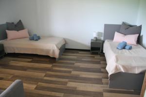 a room with two beds and a chair in it at Ferienwohnung Moin Eifel in Schleiden